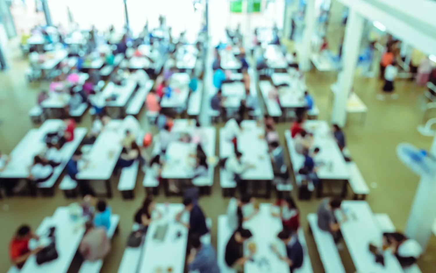Overhead view of a busy school cafeteria at lunch