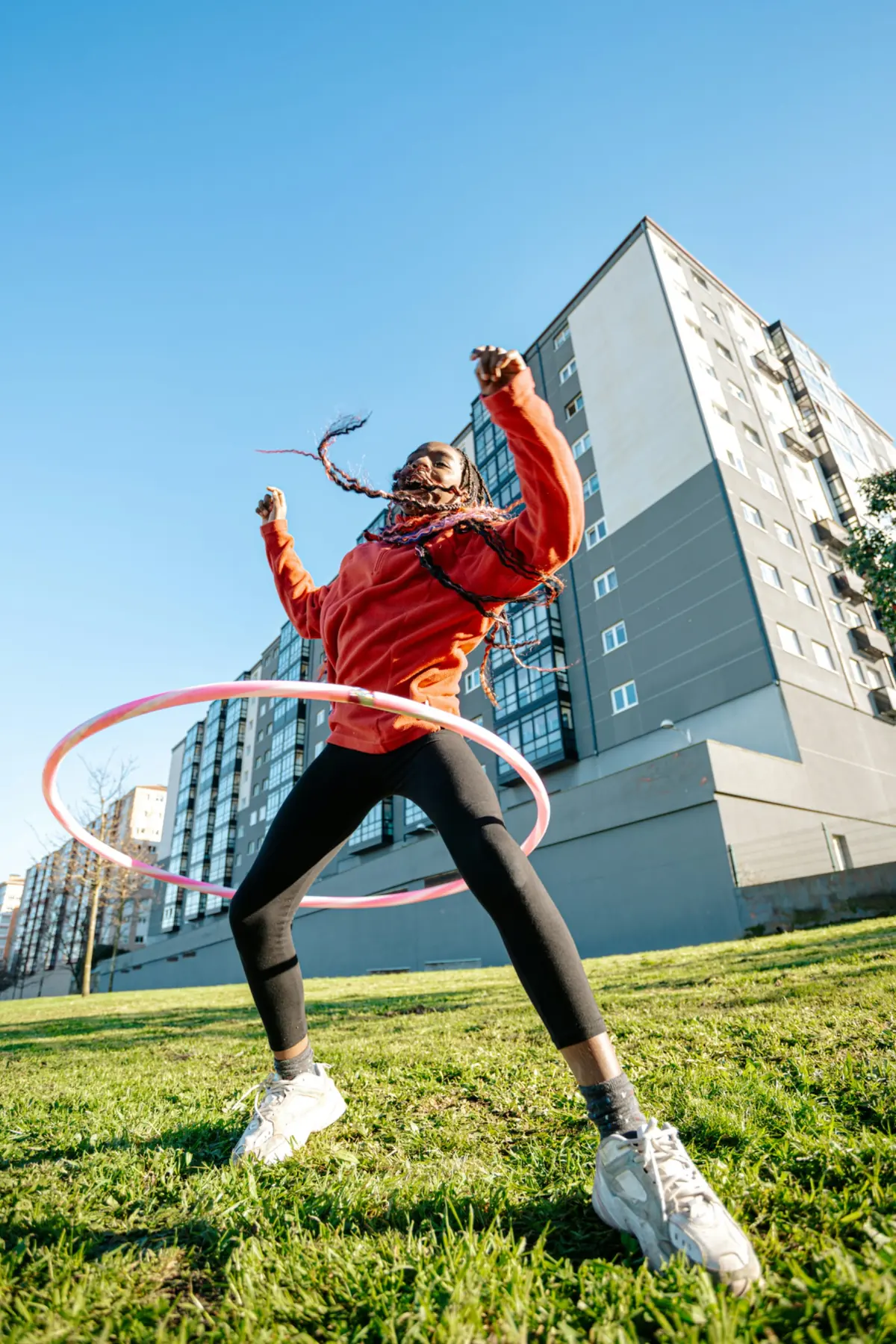 A young person with a hula hoop outdoors